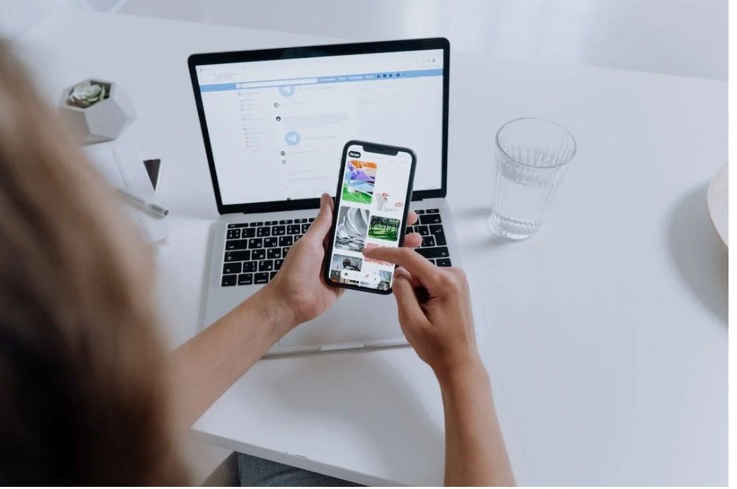 A lady using smartphone to go through the Symbiosis SET application form details.